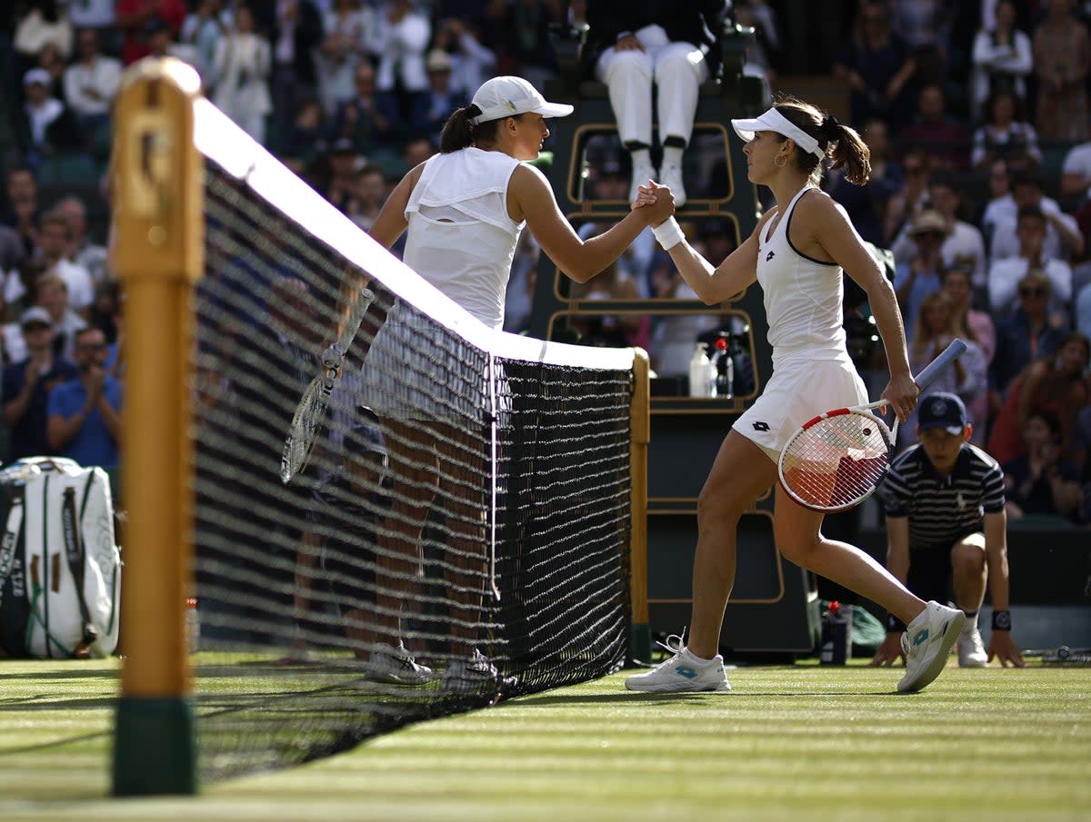 Alize Cornet shakes hands with Iga Swiatek after their third round match at Wimbledon (Steven Paston/PA) (PA Wire)