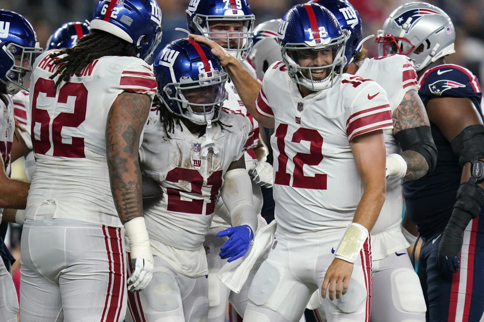 New York Giants offensive tackle Devery Hamilton (62), running back Antonio Williams (21) and quarterback Davis Webb (12) celebrate a touchdown by Williams against the New England Patriots during the second half of a preseason NFL football game Thursday, Aug. 11, 2022, in Foxborough, Mass. (AP Photo/Charles Krupa)