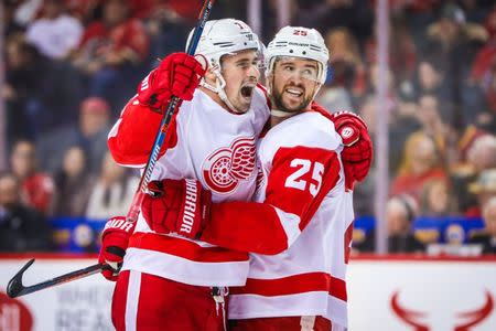 Jan 18, 2019; Calgary, Alberta, CAN; Detroit Red Wings center Dylan Larkin (71) celebrates his goal with defenseman Mike Green (25) during the second period against the Calgary Flames at Scotiabank Saddledome. Mandatory Credit: Sergei Belski-USA TODAY Sports