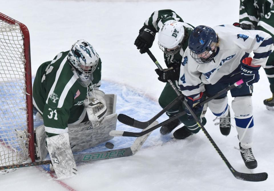 D-Y goalie Cole Rounseville defends as Sandwich's Nicholas Buckland tries to get a clear shot as Dennis-Yarmouth/Cape Cod Tech/Cape Cod Academy and Sandwich met in tournament hockey action at Gallo Arena on Thursday night.