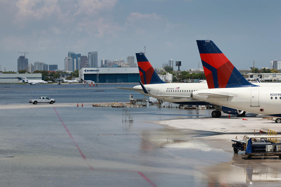 Airplanes at an airport with a wet surface