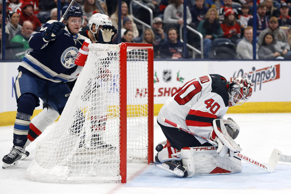 Columbus Blue Jackets forward Dmitri Voronkov, left, watches a second goal by teammate forward Kirill Marchenko (not shown) get past New Jersey Devils goalie Akira Schmid (40) during the second period an NHL hockey game in Columbus, Ohio, Saturday, Dec. 16, 2023. (AP Photo/Paul Vernon)