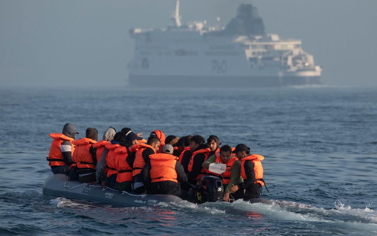 An inflatable boat carrying migrant men, women and children crosses a shipping lane in the English Channel this week - Dan Kitwood/Getty Images