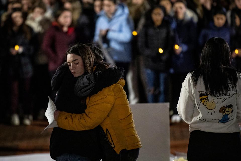 Alyssa Donovan, a UM senior from Oxford, is comforted by fellow students after speaking against gun violence as students hold a vigil for MSU shooting victims at the Diag in Ann Arbor on Wednesday, Feb. 15, 2023.