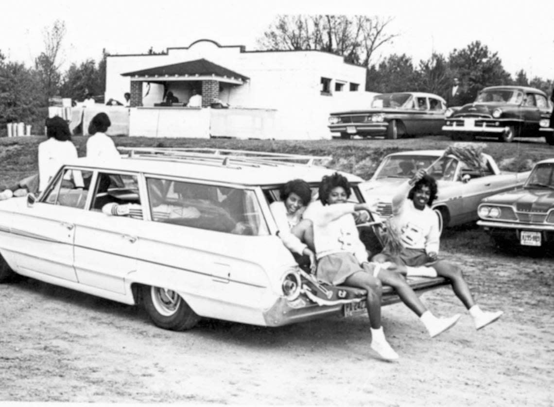 Tailgating cheerleaders ride through Raleigh’s Legion Park before a Shaw University Homecoming game.