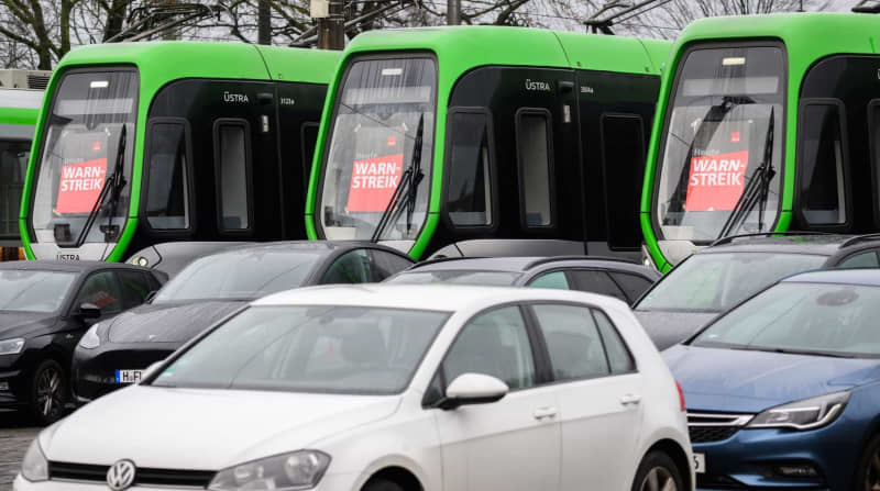 "Warning strike" posters are stuck in the front windows of the light rail vehicles. German local public transport workers plan to strike next week in every part of the country except the southern state of Bavaria, the trade union verdi announced on Thursday. Julian Stratenschulte/dpa