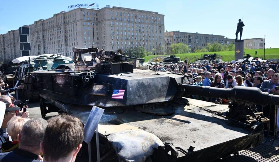 People look at a U.S.-made M12A1 Abrams tank captured by Russian forces in Ukraine, displayed at the WWII memorial complex at Poklonnya Hill western in Moscow, on May 1, 2024. (Alexander Nemenov/AFP)