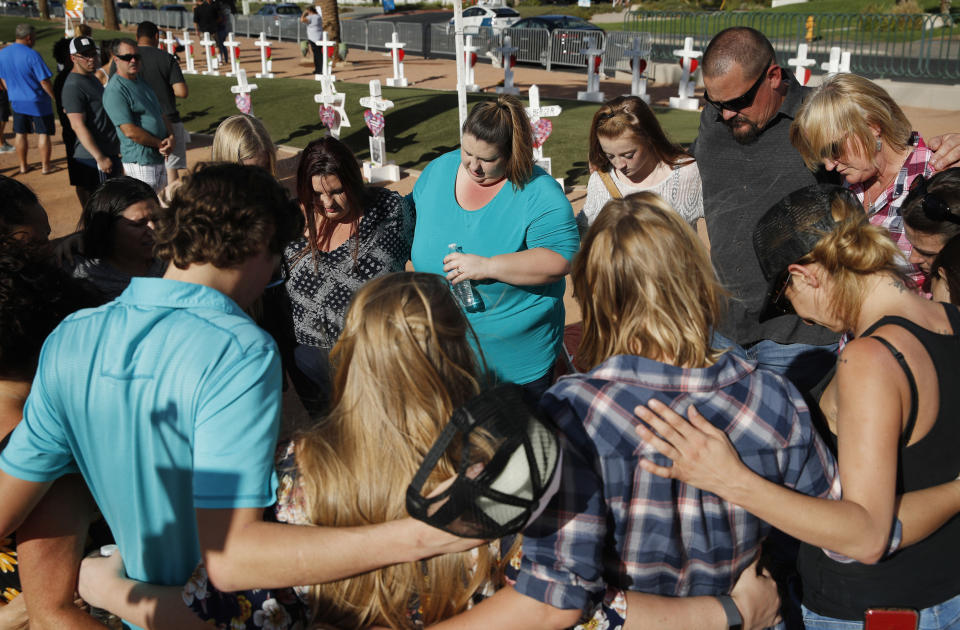 <p> People pray at a makeshift memorial for victims of the Oct. 1 2017, mass shooting in Las Vegas, Sunday, Sept. 30, 2018, in Las Vegas. (AP Photo/John Locher) </p>