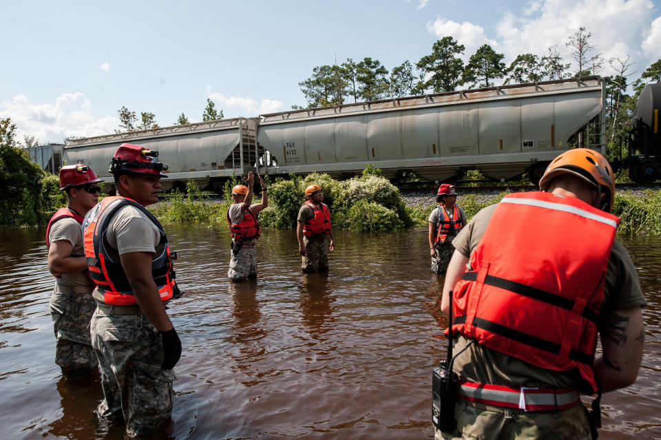 Troops get ready to unload their Zodiac boat to attempt to make it to the flooded town of Rose City.