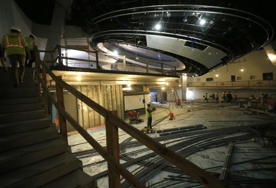 In this Thursday, Dec. 8, 2016 photo, workers pour concrete at the Patricia and Phillip Frost Museum of Science under construction in Miami. Rising next to Miami's spiffy new bayside art museum is a $305 million science museum that, like South Florida, is focused in large part on water: its centerpiece is a 500,000-gallon aquarium that will feature sharks, tuna, mahi-mahi and even sea turtles, with other smaller tanks for corals and other sea life. The Frost Science Museum, scheduled to open this spring. (AP Photo/Wilfredo Lee)