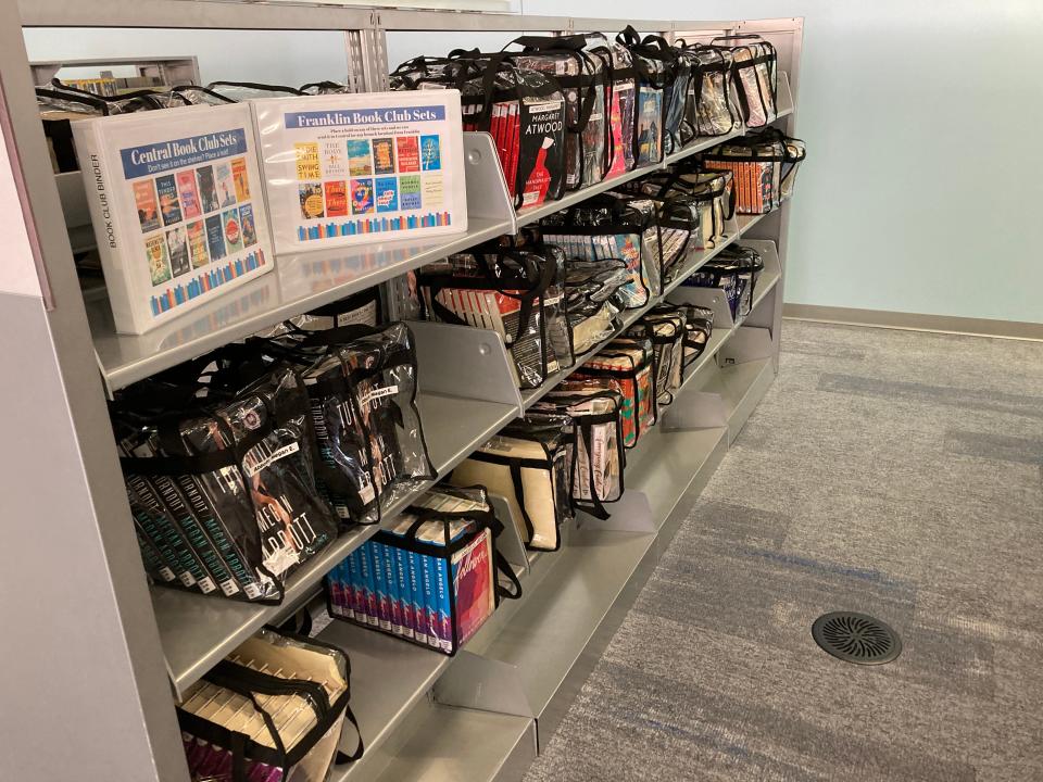 Shelves of bundled books in Des Moines Central Library can be checked out for people who want to start their own book club.