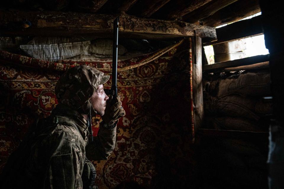 Ukrainian serviceman looks through a binocular inside a trench on the frontline near as Russia-Ukraine war continues in New York, Donbas region, Ukraine, on July 28, 2023.