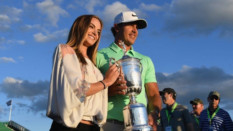 Brooks Koepka of the United States poses with the winner's trophy with Jena Sims after his victory at the 2017 U.S. Open at Erin Hills on June 18, 2017, in Hartford, Wisconsin. (Photo by Ross Kinnaird/Getty Images)