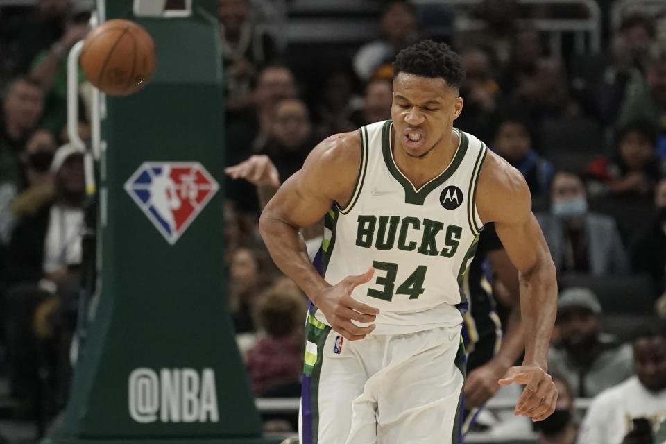 Milwaukee Bucks' Giannis Antetokounmpo reacts after scoring during the first half of an NBA basketball game against the Los Angeles Lakers Wednesday, Nov. 17, 2021, in Milwaukee. (AP Photo/Morry Gash)