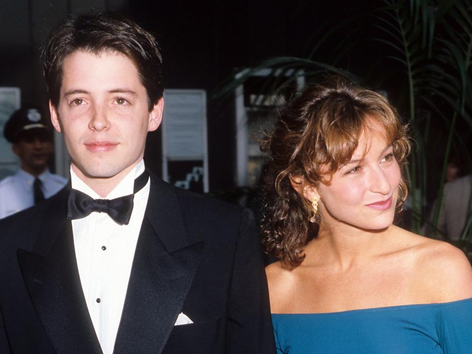 Matthew smiling in a tuxedo and Jennifer smiling in an off-the-shoulder teal dress.
