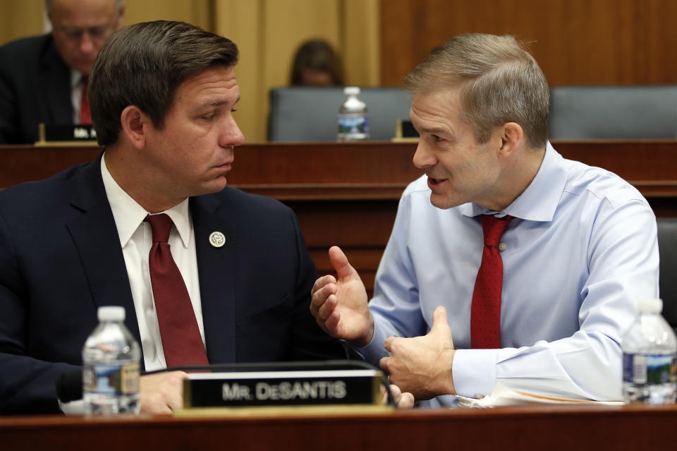 FILE - House Judiciary Committee member Rep. Jim Jordan, R-Ohio, right, and Rep. Ron Desantis, R-Fla., talk as FBI Director Christopher Wray testifies during a House Judiciary hearing on Capitol Hill in Washington, Dec. 7, 2017, on Oversight of the Federal Bureau of Investigation. (AP Photo/Carolyn Kaster, File)