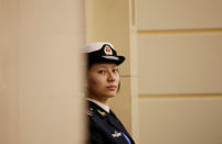 A female soldier of the People's Liberation Army (PLA) Navy stands guard at a news conference ahead of the 70th anniversary of the founding of Chinese People's Liberation Army Navy, in Qingdao, China, April 20, 2019. REUTERS/Jason Lee