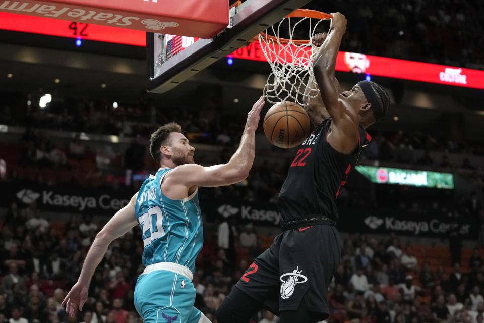 Miami Heat forward Jimmy Butler (22) dunks over Charlotte Hornets forward Gordon Hayward (20) during the first half of an NBA basketball game, Wednesday, Dec. 13, 2023, in Miami. (AP Photo/Lynne Sladky)