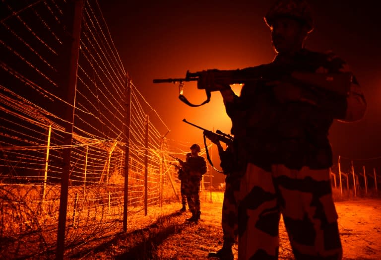 Indian Border Security Force (BSF) soldiers patrol along the border between India and Pakistan near Jammu