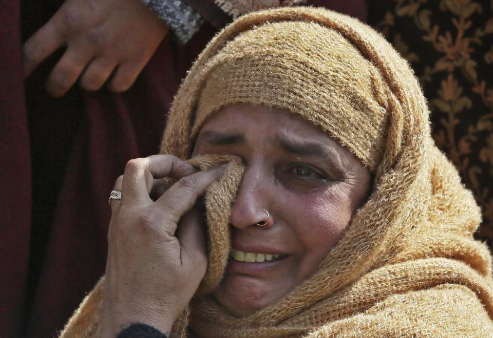 Unidentified relatives of Taja begum, a 60-year-old woman who was killed in shootout grieve at her residence in Moul village, 62 kilometers (39 miles) south of Srinagar, Indian controlled Kashmir, Thursday, Feb.23, 2017. Three Indian soldiers and a woman were killed after rebels ambushed soldiers in the disputed region of Kashmir, police said on Thursday. According to police, the attack triggered a brief exchange of gunfire and a stray bullet hit the 60-year-old woman while she was sleeping in her home. (AP Photo/Mukhtar Khan)