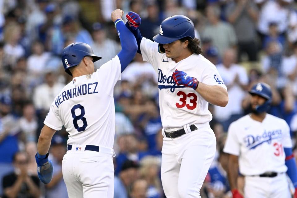 James Outman celebrates with Dodgers teammate Kiké Hernández after hitting a two-run home run.