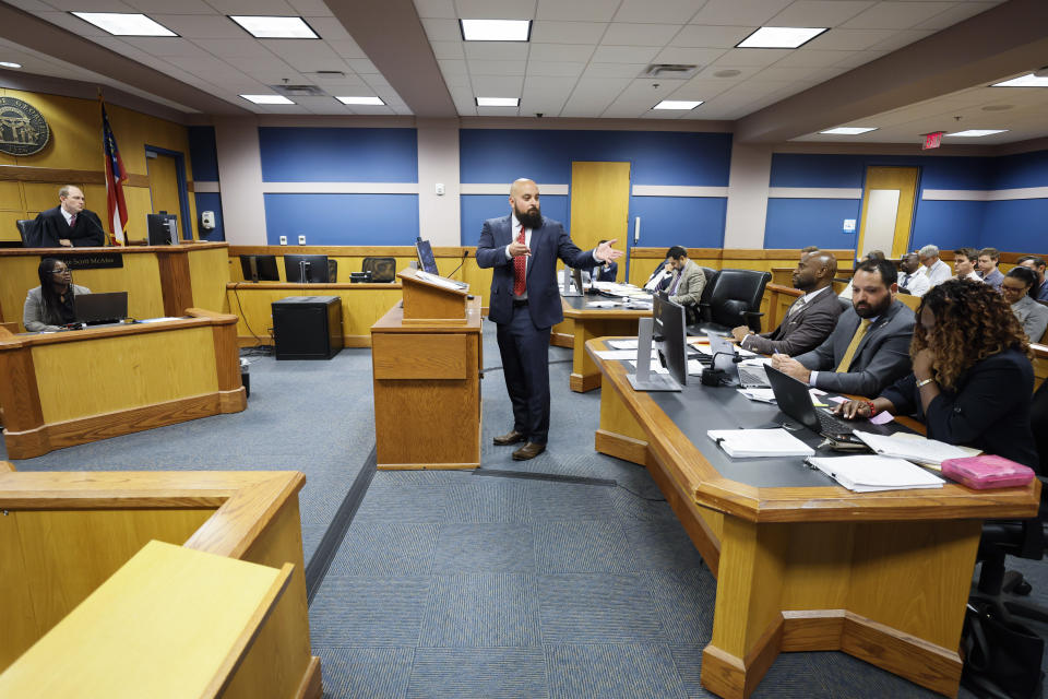 Attorney Scott Grubman, who is defending Kenneth Chesebro, speaks before Fulton County Superior Court Judge Scott McAfee, left, in Atlanta on Thursday, Sept. 14, 2023. Donald Trump will not face trial next month in Georgia after McAfee ruled Thursday that the former president and 16 others accused of illegally trying to overturn the results of the 2020 election will be tried separately from two lawyers in the case. Lawyers Sidney Powell and Chesebro had filed demands for a speedy trial, and McAfee set their trial to begin Oct. 23. (Miguel Martinez/Atlanta Journal-Constitution via AP, Pool)