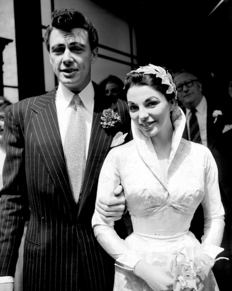 <p>In her first of five marriages, British actress Joan Collins married Maxwell Reed at Caxton Hall in London. The ceremony included friends and family and the bride wore a high collared brocade satin wedding gown. </p>