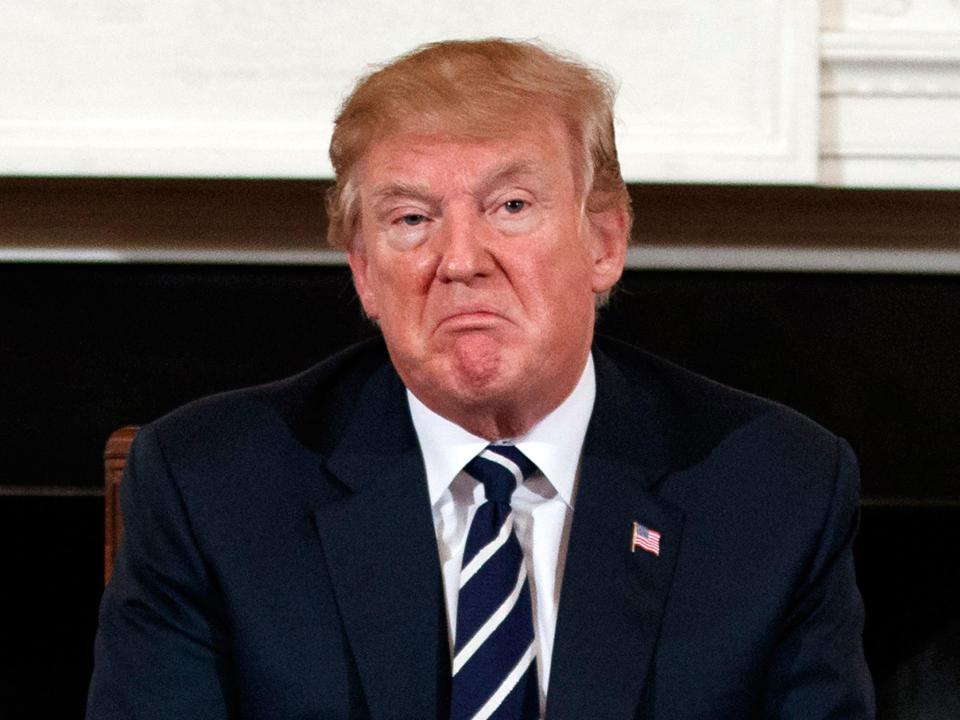 Donald Trump pauses during a listening session with high school students, teachers and others in the State Dining Room of the White House: AP