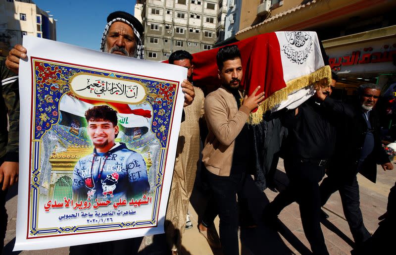 Mourners carry a coffin of a demonstrator who was killed at an anti-government protest overnight in Nassiriya, during a funeral in Najaf