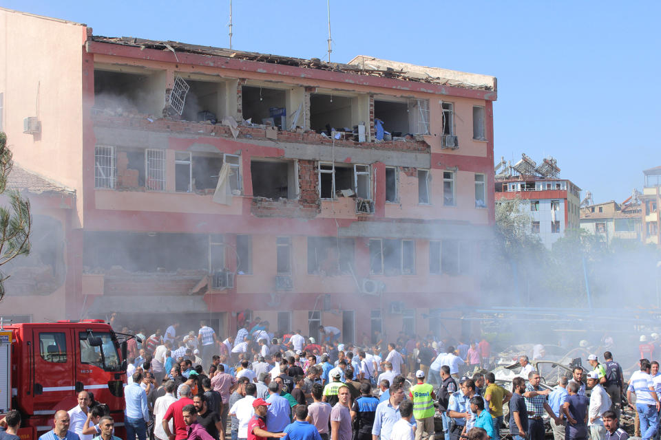 People rush to the blast scene after a car bomb attack