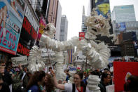 Protesters walk through Times Square during the Earth Day 'March For Science NYC' demonstration to coincide with similar marches globally in Manhattan, New York, U.S., April 22, 2017. REUTERS/Andrew Kelly
