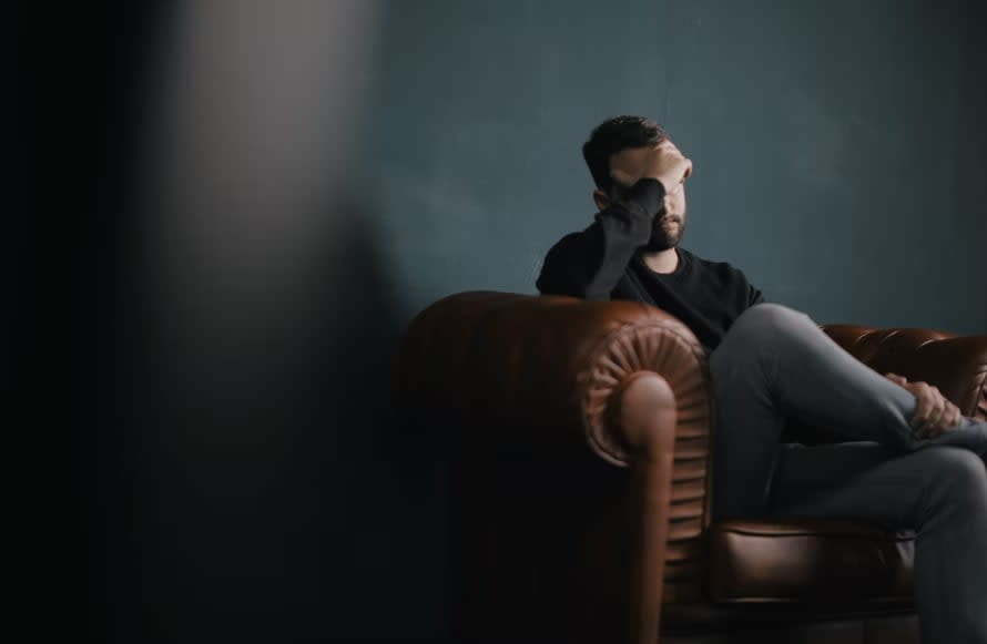 Distressed man sitting on couch