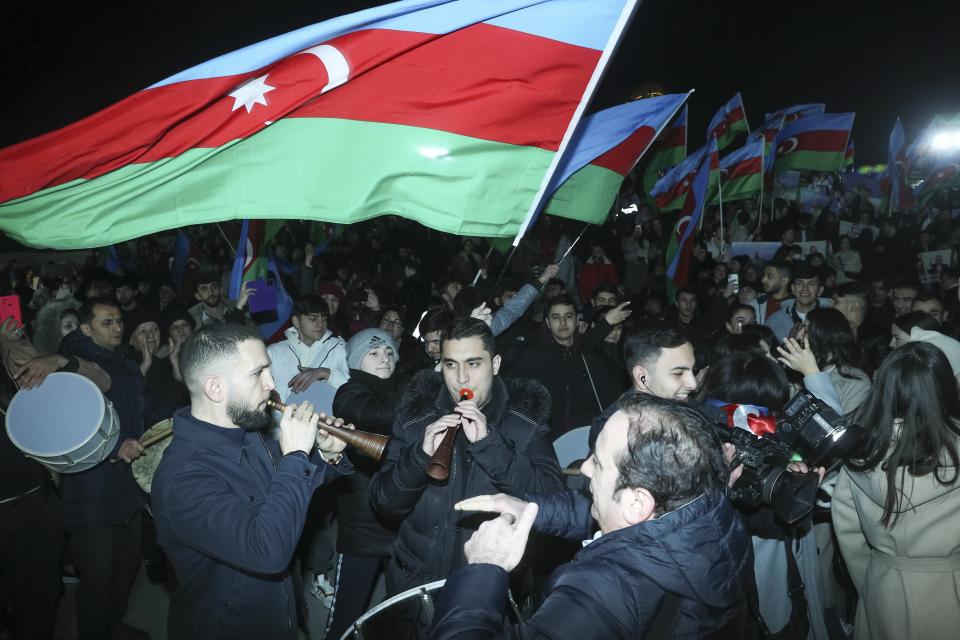 People wave national flags celebrating Azerbaijan's President Ilhan Aliyev's victory in the presidential election in Baku, Azerbaijan, Wednesday, Feb. 7, 2024. Azerbaijanis voted Wednesday in an election almost certain to see incumbent President Ilhan Aliyev chosen to serve another seven-year term. (AP Photo)