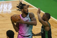 Miami Heat's Trevor Ariza, left, looks for an opening as Boston Celtics' Kemba Walker (8) tries to block in the first half of a basketball game, Sunday, May 9, 2021, in Boston. (AP Photo/Steven Senne)