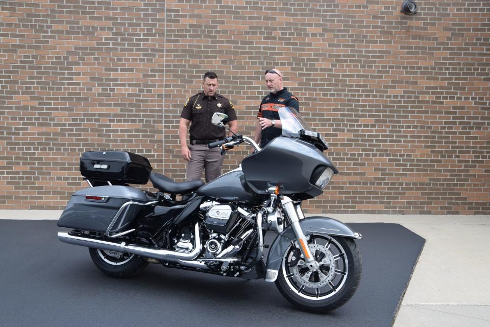 Lt. Andrew LaLonde and Jeff Dickey look at the 2024 Road Glide, which is now a part of the Cheboygan County fleet.