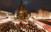 NUREMBERG, GERMANY - NOVEMBER 30: Visitors attend the opening ceremony of the traditional Christmas market 'Nuernberger Christkindlesmarkt' on November 30, 2012 in Nuremberg, Germany. Originating in the 16th century the Nuremberg Christmas market is seen as one of the oldest of its kind in Germany. (Photo by Johannes Simon/Getty Images)