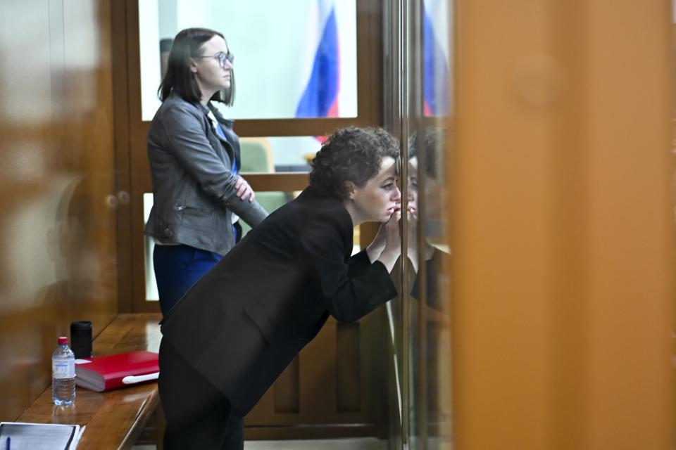 Theater director Zhenya Berkovich, foreground, and playwright Svetlana Petriychuk are seen in a glass cage prior to a hearing in a court in Moscow, Russia, on Monday, May 20, 2024. Berkovich, a prominent independent theater director, and Petriychuk, a playwright have been behind bars since early May. Authorities claim a play they staged, "Finist, the Brave Falcon," justifies terrorism, which is a criminal offence in Russia punishable by up to seven years in prison. (AP Photo/Dmitry Serebryakov)