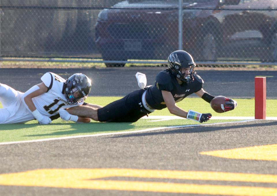 Bushland's Cole Purcell (14) stretches for a touchdown against Canadian, Friday, Sept. 2, 2022, at Falcon Stadium in Bushland.