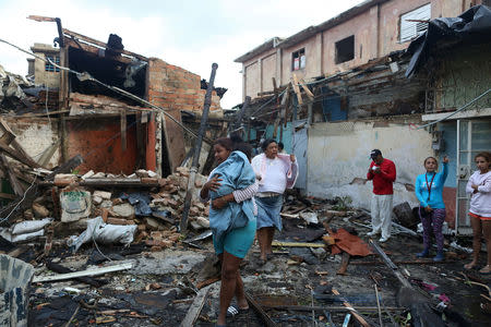 People walk among the debris after a tornado ripped through a neighbourhood in Havana, Cuba January 28, 2019. REUTERS/Fernando Medina