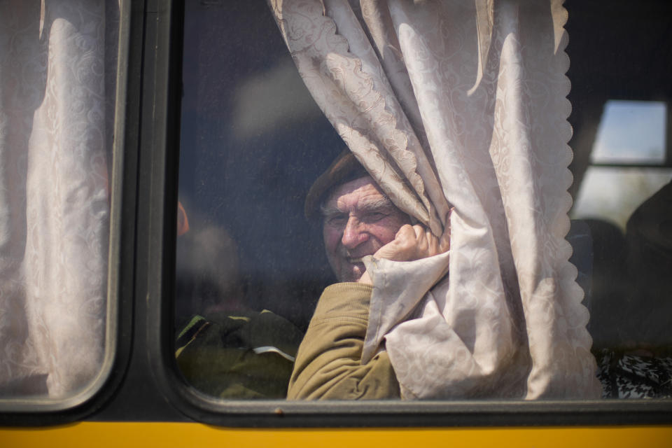 A man waits in a bus to be processed as he arrives with others at a reception center for displaced people in Zaporizhzhia, Ukraine, Monday, May 2, 2022. Thousands of Ukrainian continue to leave Russian occupied areas. (AP Photo/Francisco Seco)