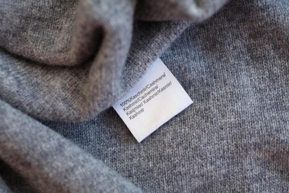 A close up of the care label of a grey cashmere sweater