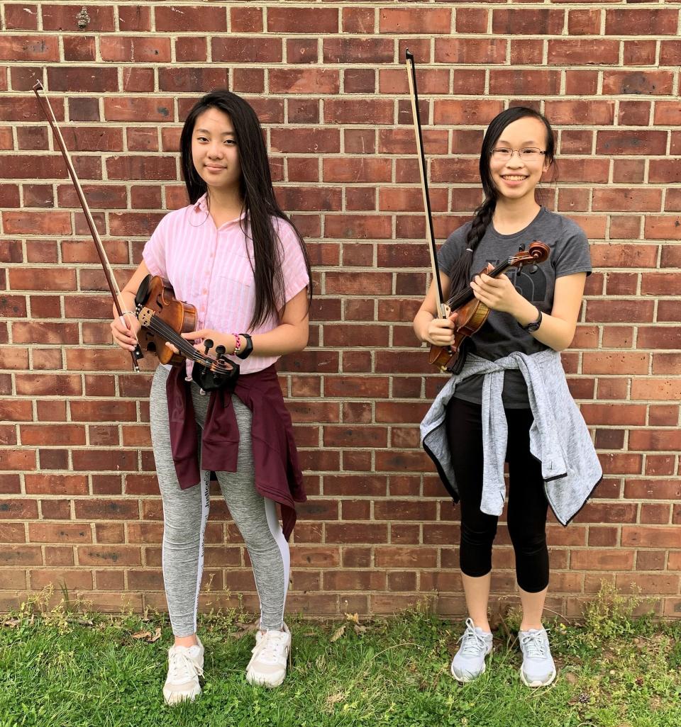 Edison Intermediate School seventh grader Mai Kim (left) and eight grader Madeline Yong will perform with the All-State Intermediate Orchestra, both playing violin.