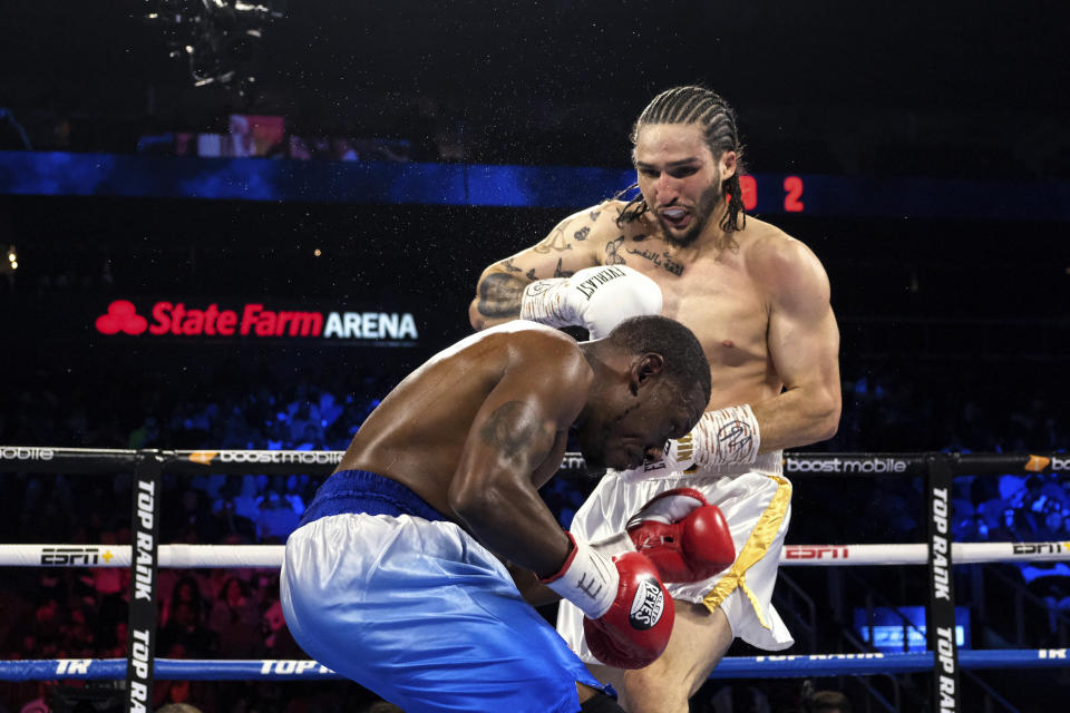Niko Ali Walsh, grandson of Muhammad Ali, hits James Westley II during a middleweight boxing match in Atlanta on Saturday night, Oct. 23, 2021. Walsh won in the third round. (AP Photo/Ben Gray)