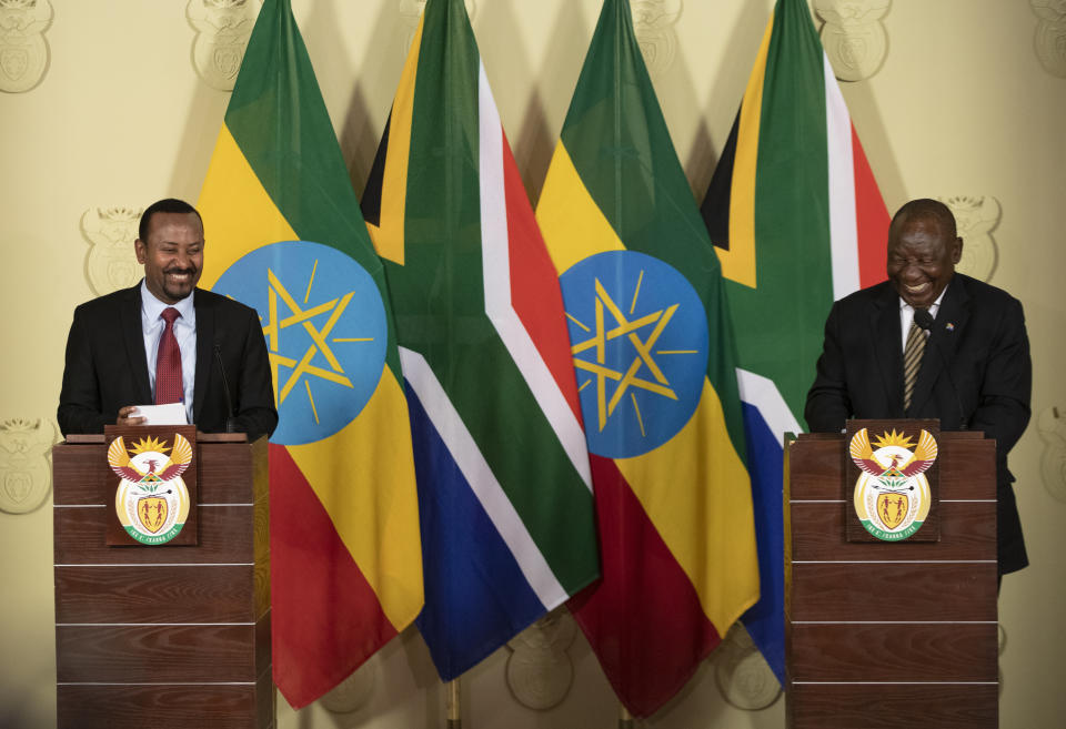 South African President Cyril Ramaphosa, right, shares a light moment with Ethiopia's Prime Minister Abiy Ahmed during their joint media conference at the Union Building in Pretoria, South Africa, Sunday, Jan. 12, 2020. (AP Photo/Themba Hadebe)