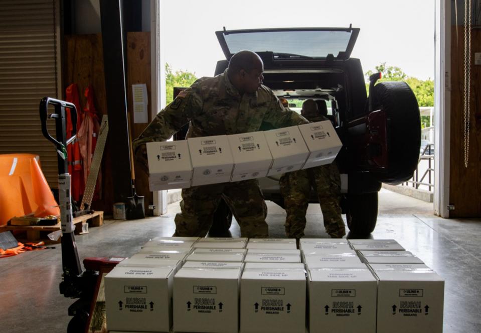 Alabama National Guard Sgt. Patris Bivens, 135th Expeditionary Sustainment Command (ESC), loads COVID 19 test kits for transport at the Alabama Department of Public Health Warehouse in Montgomery, Alabama, April 22, 2020.