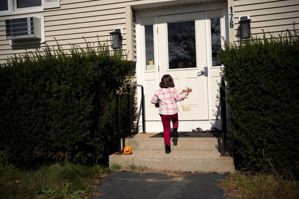 A child is seen heading into a house.