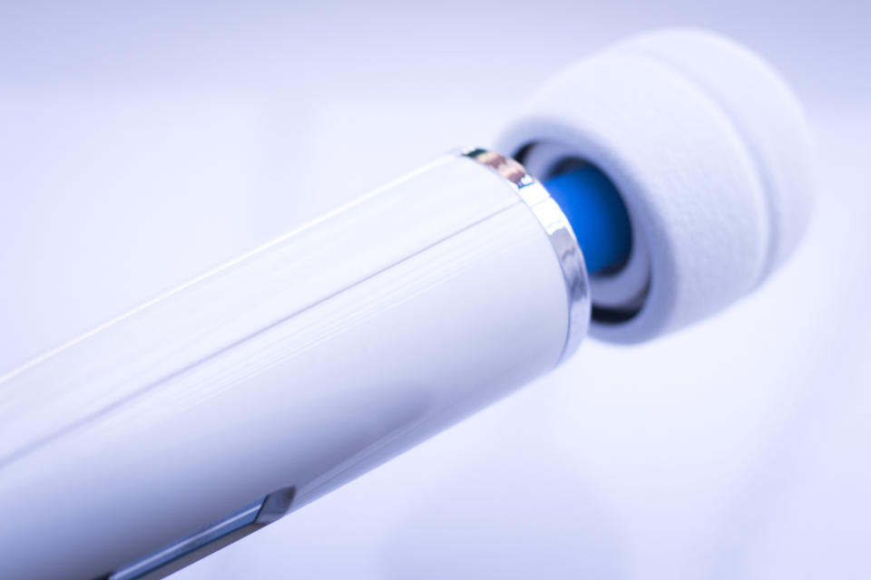 Close-up of a white personal massager with a blue detail