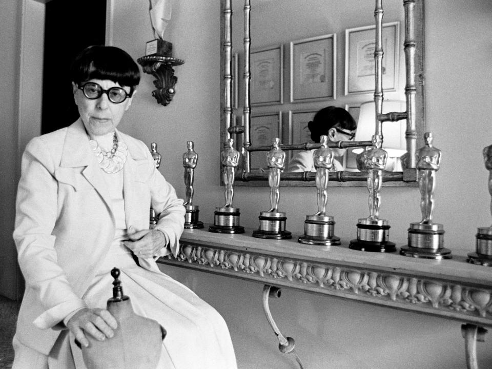 Edith Head poses with some of her Academy Awards in 1975.