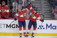 Florida Panthers center Carter Verhaeghe, right, is congratulated by defenseman Niko Mikkola after Verhaeghe scored during the second period of Game 5 of the first-round of an NHL Stanley Cup Playoff series against the Tampa Bay Lightning, Monday, April 29, 2024, in Sunrise, Fla. (AP Photo/Wilfredo Lee)