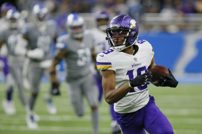 Minnesota Vikings wide receiver Justin Jefferson runs ahead of the Detroit Lions defense during the first half of an NFL football game, Sunday, Dec. 5, 2021, in Detroit. (AP Photo/Duane Burleson)